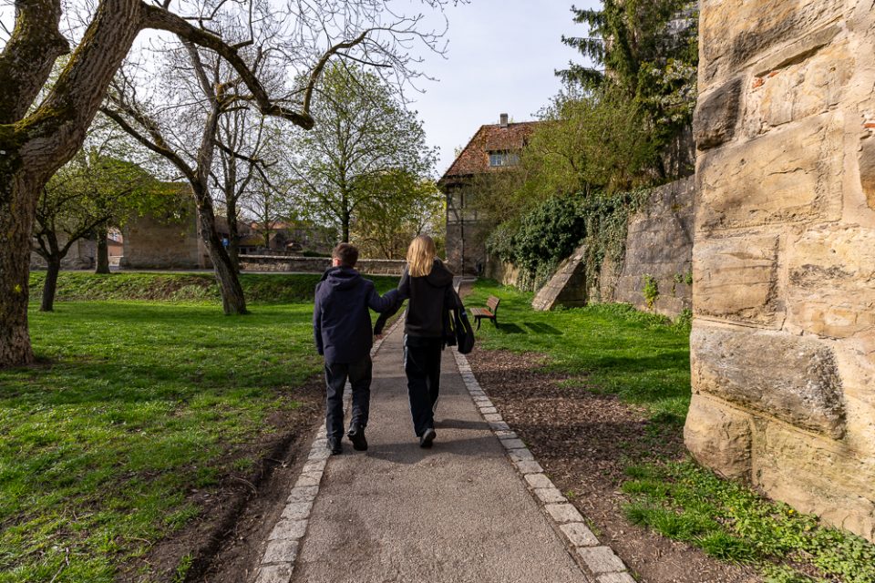 Kinder laufen an der Stadtmauer entlang in Rothenburg ob der Tauber