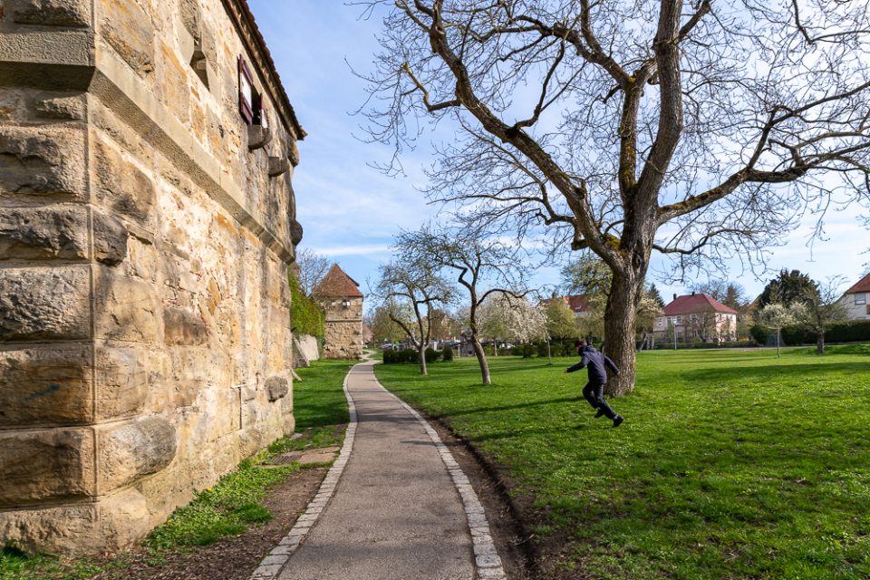 Kind spielt an der Stadtmauer